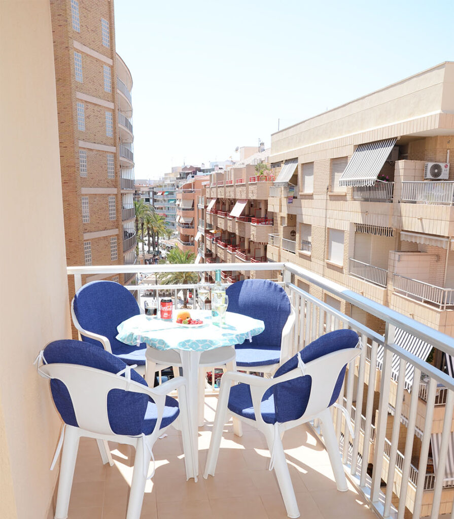 Balcony with table and chairs.