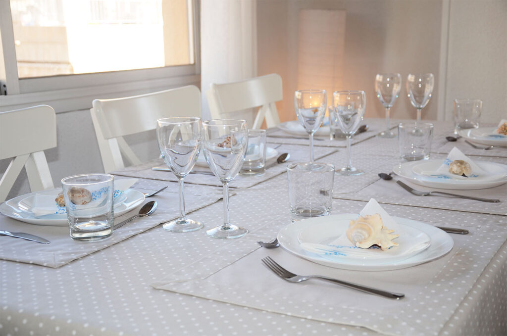 Dining table set for dinner with plates and glasses