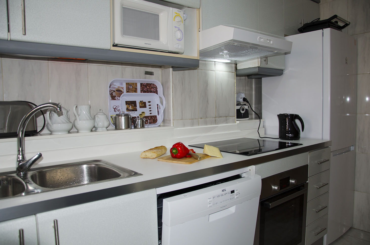 Modern kitchen with dishwasher, oven and fridge