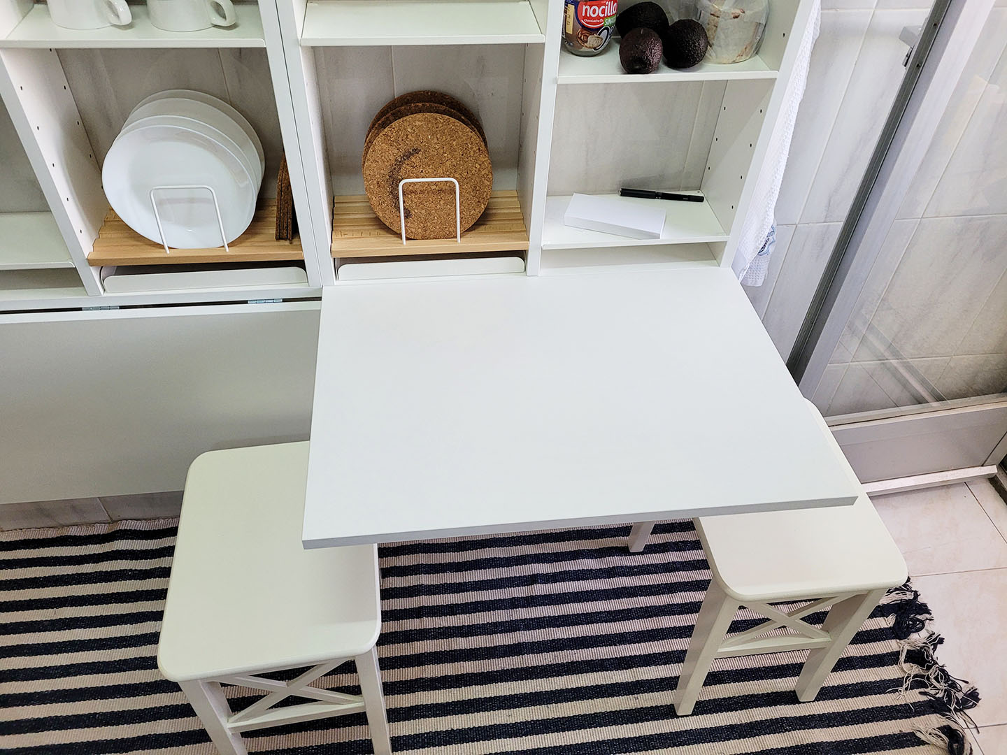 Drop leaf table with two stools.